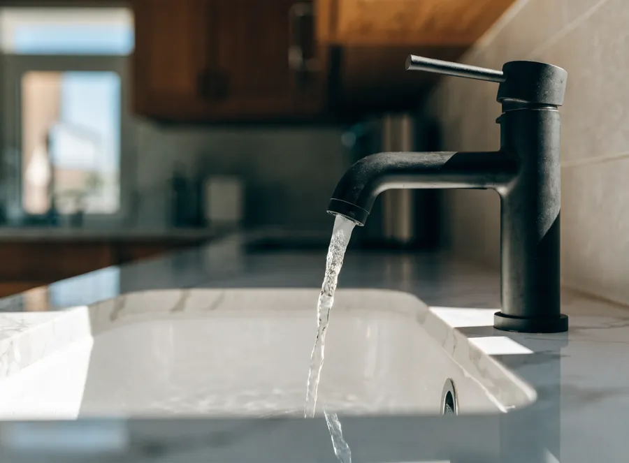 Water running from a new black kitchen faucet